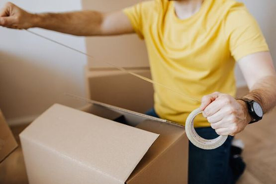 hombre embalando una caja